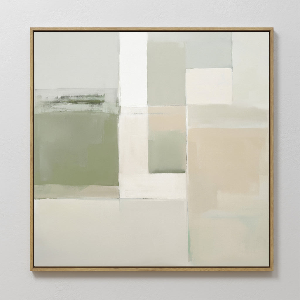 The Soft Geometric Planes Canvas Art - Square features a minimalist abstract design with soft blocks of green, beige, white, and gray. Varied rectangular shapes create calming wall art, all presented in a thin light wood frame.