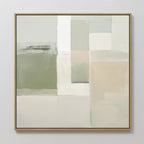 The Soft Geometric Planes Canvas Art - Square features a minimalist abstract design with soft blocks of green, beige, white, and gray. Varied rectangular shapes create calming wall art, all presented in a thin light wood frame.