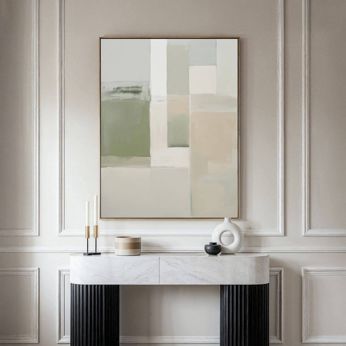 A minimalist console table with decorative objects stands against an elegantly paneled wall, topped by the Soft Geometric Planes Canvas Art - Vertical in neutral beige, green, and white tones for a contemporary look.