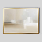 The Soft Layers Canvas Art - Horizontal features a gold-framed abstract design with smooth beige, white, and light gray tones. This minimalist modern print is displayed against a plain gray background for a sophisticated touch.