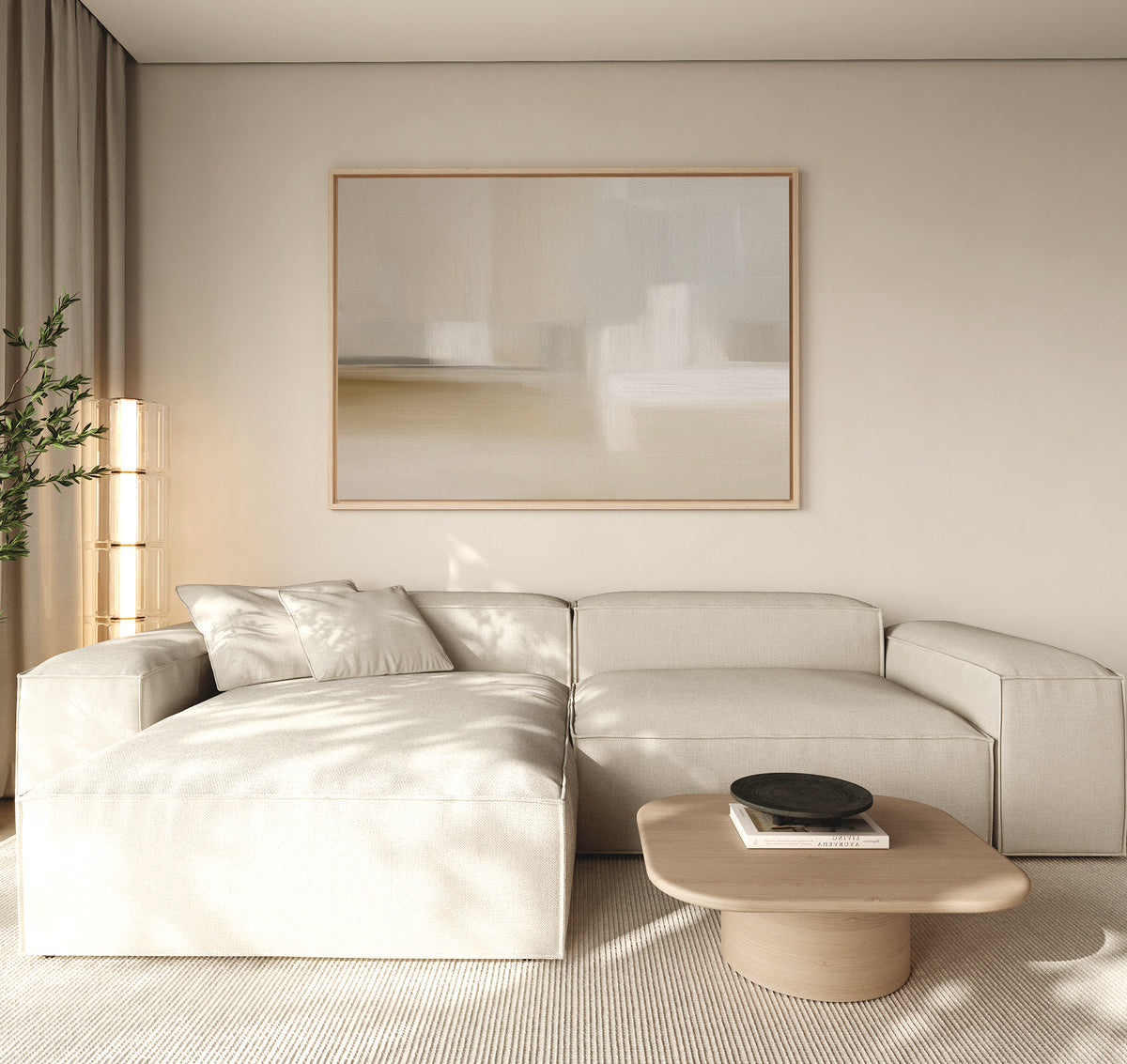 A minimal living room features a light beige sectional sofa, a Soft Layers Canvas Art - Horizontal on the wall, a wooden coffee table with a black bowl, and soft natural light through a window with beige curtains.