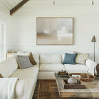 A bright, cozy living room with white shiplap walls, a white sectional with textured pillows, a rustic wooden coffee table, and the Soft Layers Canvas Art - Horizontal on the wall. Neutral tones and natural light create an inviting feel.