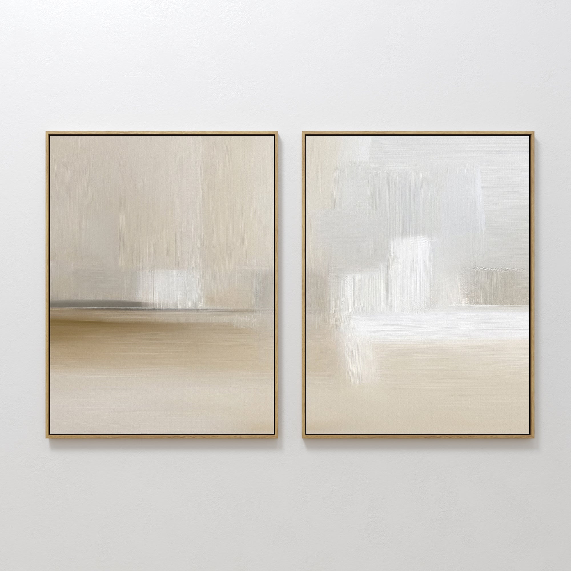 The "Soft Layers - Set Of 2" features two minimalist abstract prints with smooth, blurred brushstrokes in beige, cream, and white tones. Each print is framed in thin gold and displayed side by side on a plain white wall.
