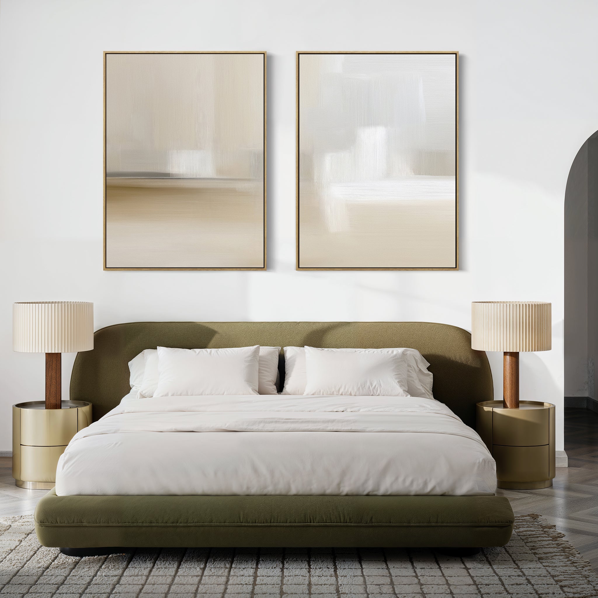 A modern bedroom with a low olive-green bed, white bedding, gold nightstands, and beige lamps. The "Soft Layers - Set Of 2" minimalist abstract prints in neutral tones hang above the bed, enhancing the soft, minimalist vibe.