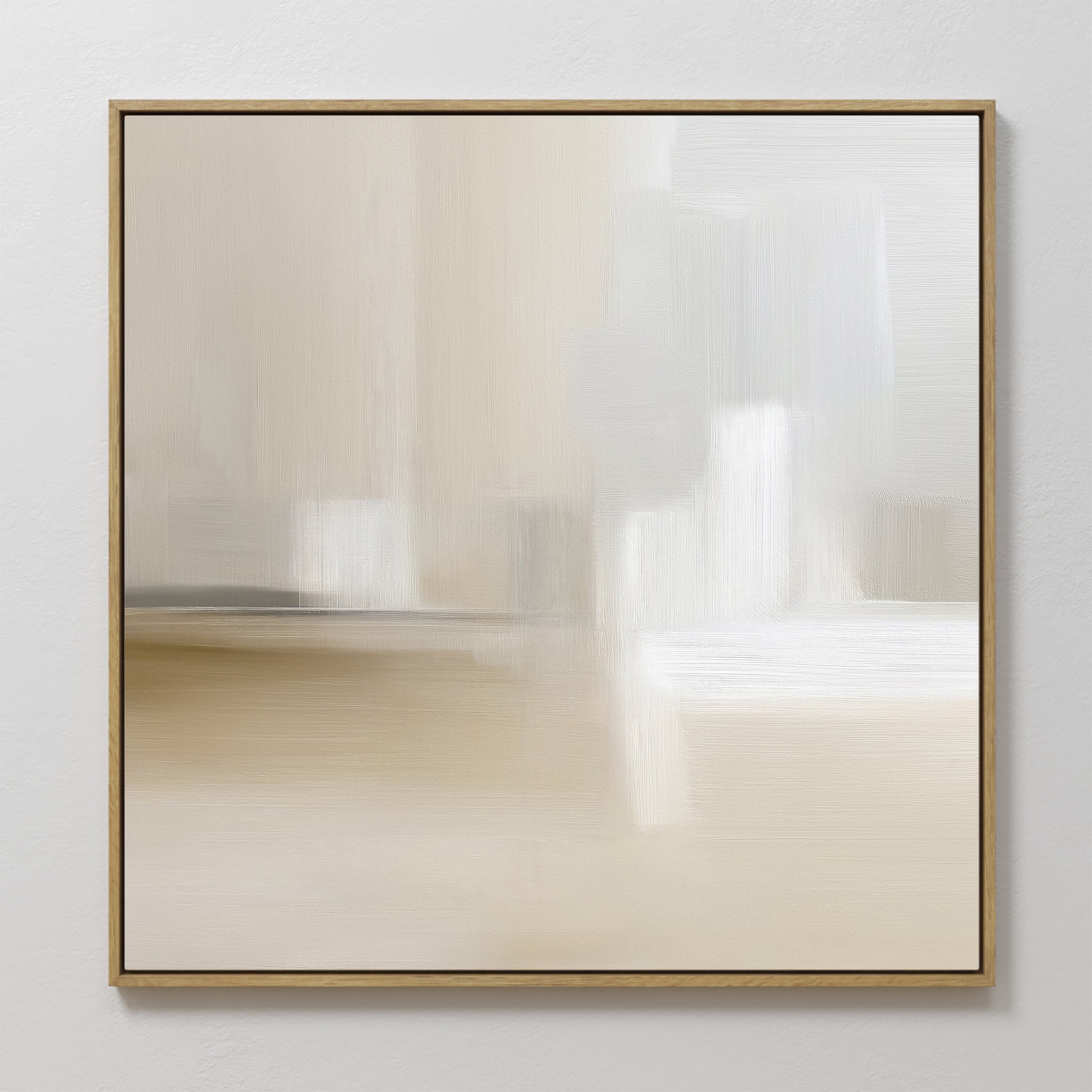 The Soft Layers Canvas Art - Square features abstract, blurred brushstrokes in soft beige, cream, and white. Framed with a slim frame and displayed on a light wall, it adds a calm, minimalist touch to any space.