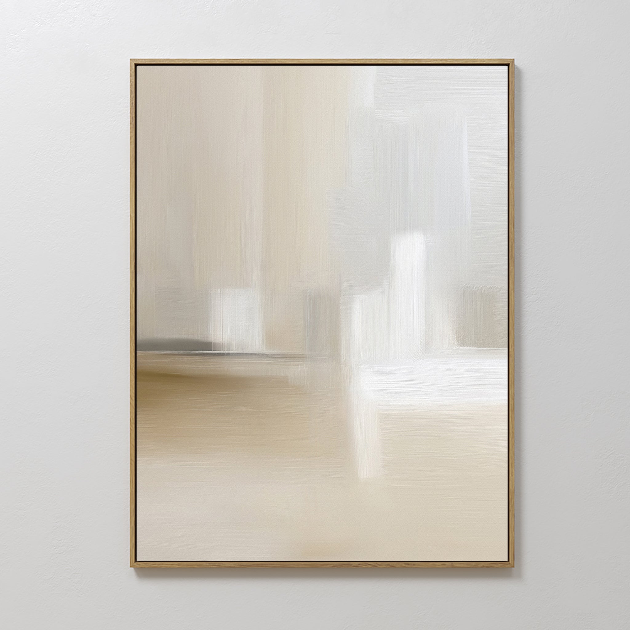 The Soft Layers Canvas Art - Vertical features abstract, minimalist beige, white, and gray tones. Framed in a slim light frame, this calming neutral wall art is displayed on a plain white wall.