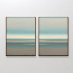 The Soft Tide Layers - Set Of 2 features two framed abstract prints with horizontal bands in soft blue, beige, and muted brown tones, creating a calming coastal wall art effect against a white wall.