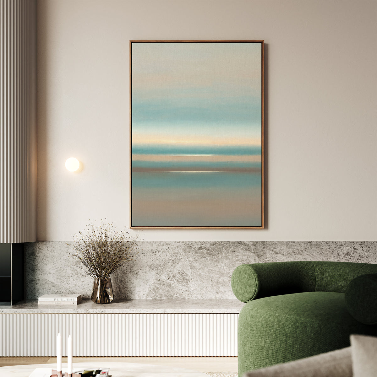 A modern living room with a green curved sofa, a marble ledge holding a vase of dried branches, and the Soft Tide Layers Canvas Art - Vertical in calming pastel hues hanging on the beige wall above the ledge.