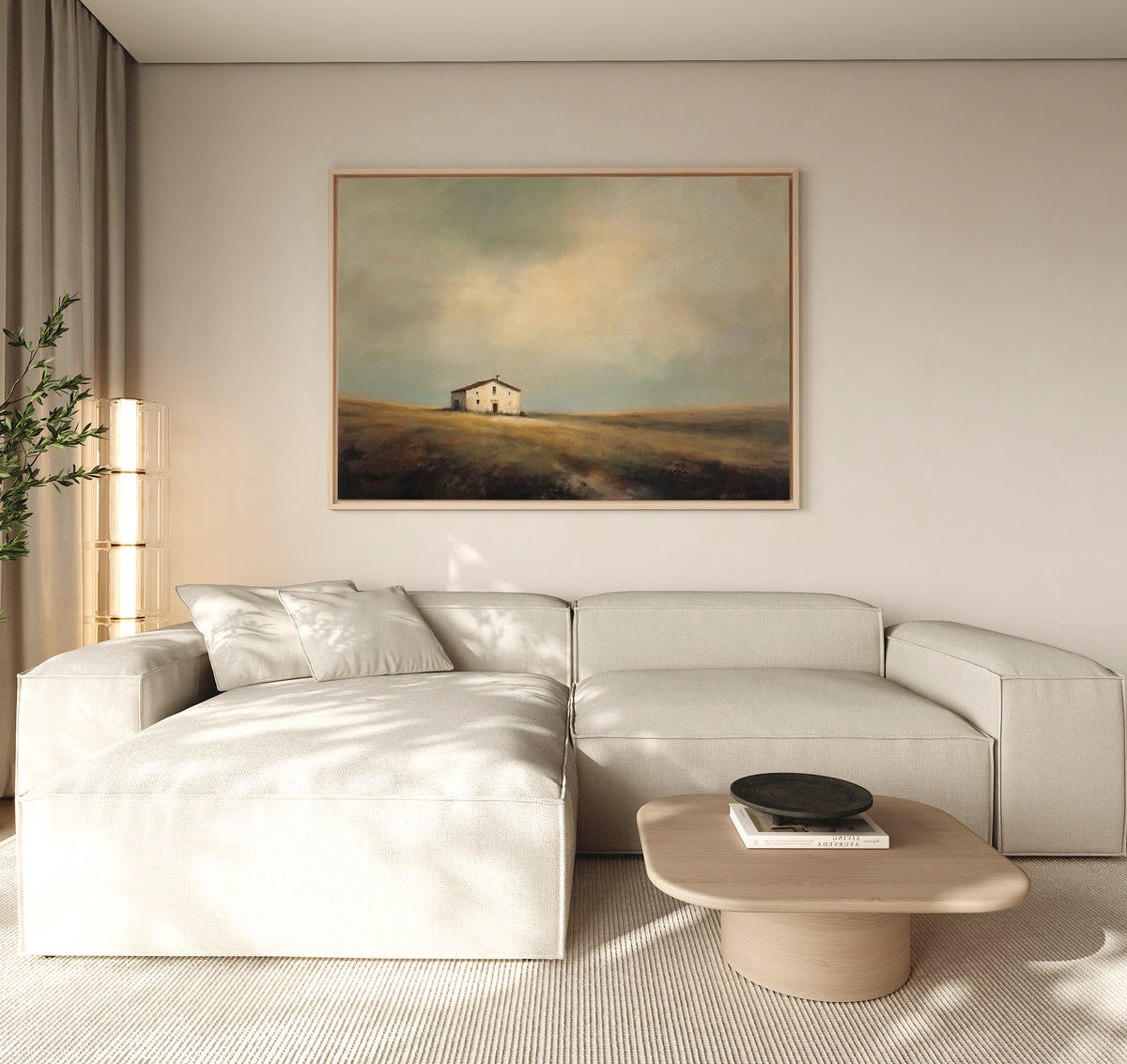 A modern, minimalist living room features a light beige sectional sofa, a low wooden coffee table, and the Solitary House Canvas Art - Horizontal above the sofa for rustic charm. Natural light fills the space.