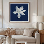 A modern living room with a beige sofa, neutral cushions, a side table with a lamp, and the Starlit Magnolia Canvas Art - Square hanging above the sofa adds elegant contemporary style to the space.