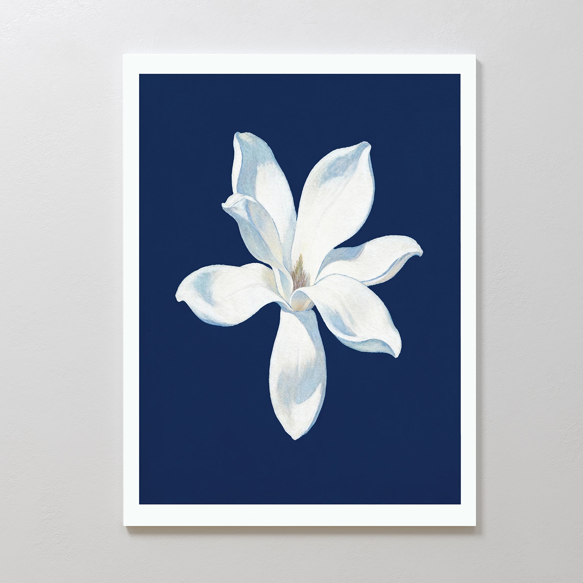 Starlit Magnolia Canvas Art - Vertical features a minimalist white magnolia with soft shadows on a dark blue background, framed in white—a modern wall art piece ideal for Nordic Park-inspired decor.