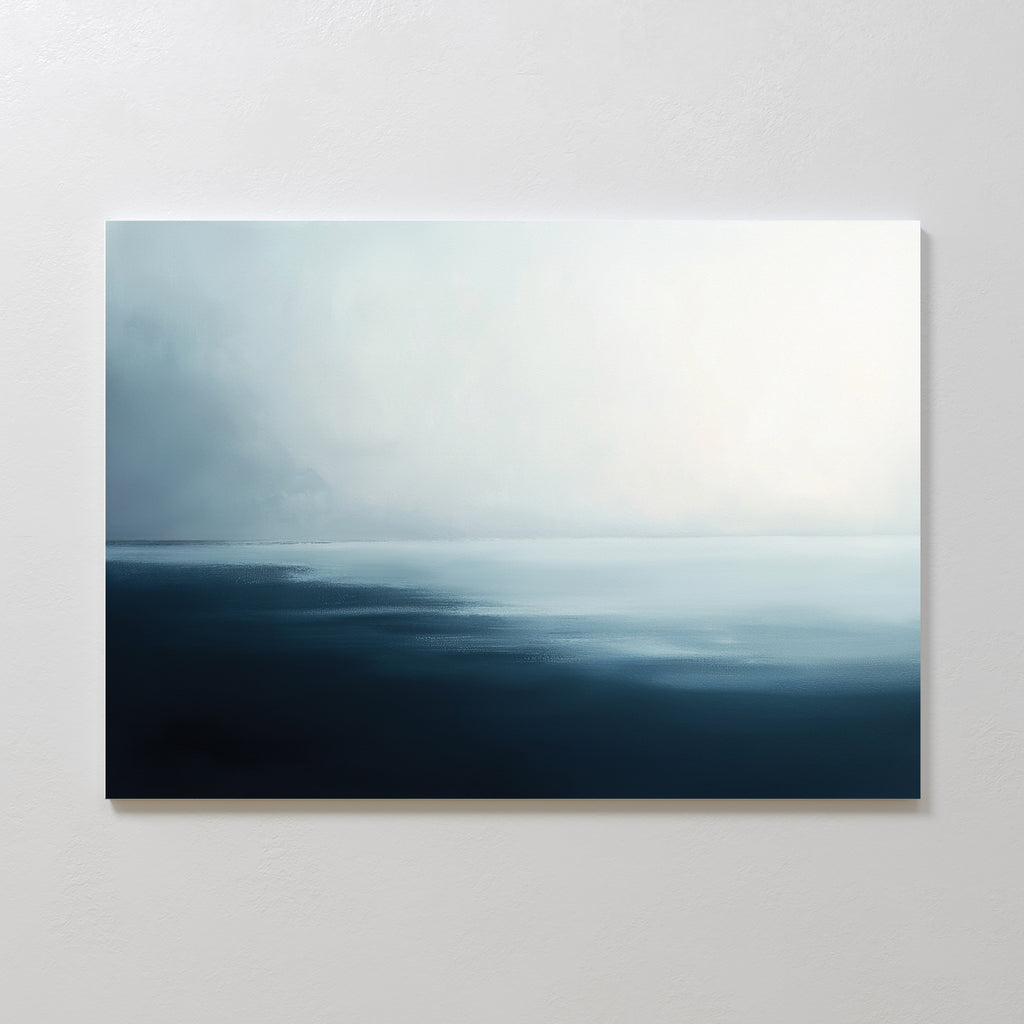 Steel Harbor Mist Canvas Art - Horizontal captures a minimalist seascape with dark blue water blending into soft white and gray skies, evoking Nordic Park tranquility. Displayed on a light wall, it brings serene vibes to any space.