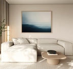 A modern living room with a light beige sectional sofa, low wooden coffee table, tall plant, and the Steel Harbor Mist Canvas Art - Horizontal above the sofa. Natural light from the left creates a serene Nordic Park ambiance.