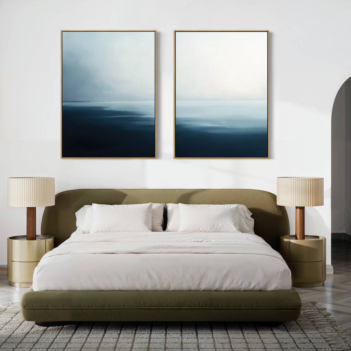 A modern bedroom features an olive green bed, white bedding, and the Steel Harbor Mist - Set Of 2 beige table lamps on round nightstands, while abstract blue and white artwork above the headboard adds a Nordic Park vibe.
