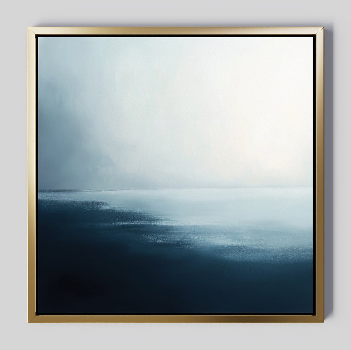 The Steel Harbor Mist Canvas Art - Square features minimalist wall art in a gold frame, showcasing a serene abstract seascape with soft blue and white gradients that evoke calm water and a misty horizon.