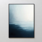 The Steel Harbor Mist Canvas Art - Vertical features a gradient from deep navy to soft white, evoking a calm seascape. Framed on a plain white wall, it adds serene elegance and minimalist style to any living room.