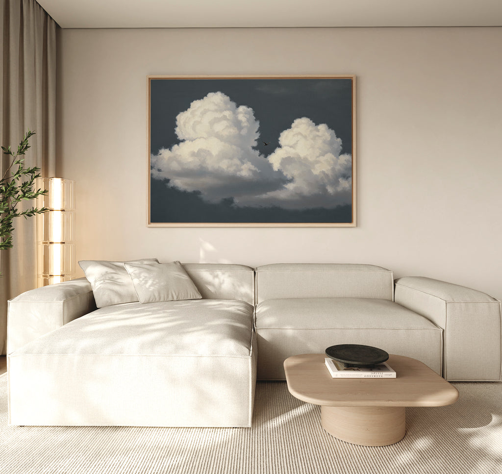 A living room with a large white couch and the Storm Passage Canvas Art - Horizontal on the wall.