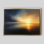 Storm's Edge Canvas Art - Horizontal features a sunset over calm water with warm golden and orange tones blending into deep blue shades, all enhanced by a simple gold-colored frame.