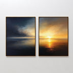 Storm's Edge - Set of 2: Two framed canvas prints hang side by side on a white wall, showcasing dramatic seascapes—one with storm clouds and the other with a golden sunset reflected on tranquil water.