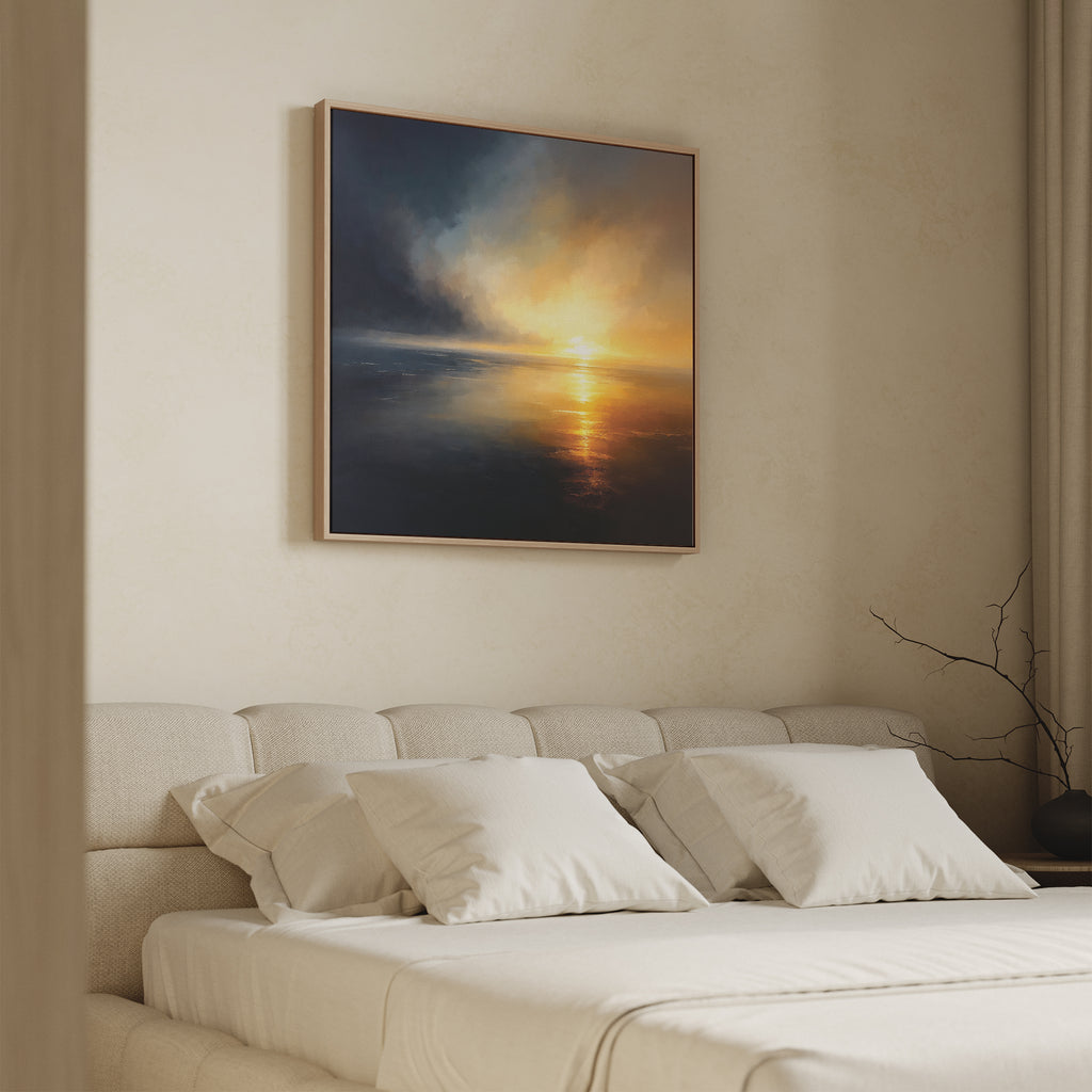 A beige bedroom features a cushioned headboard, neatly made bed with white pillows and sheets, and the Storm's Edge Canvas Art - Square above the bed. A small bare branch decorates the side table.