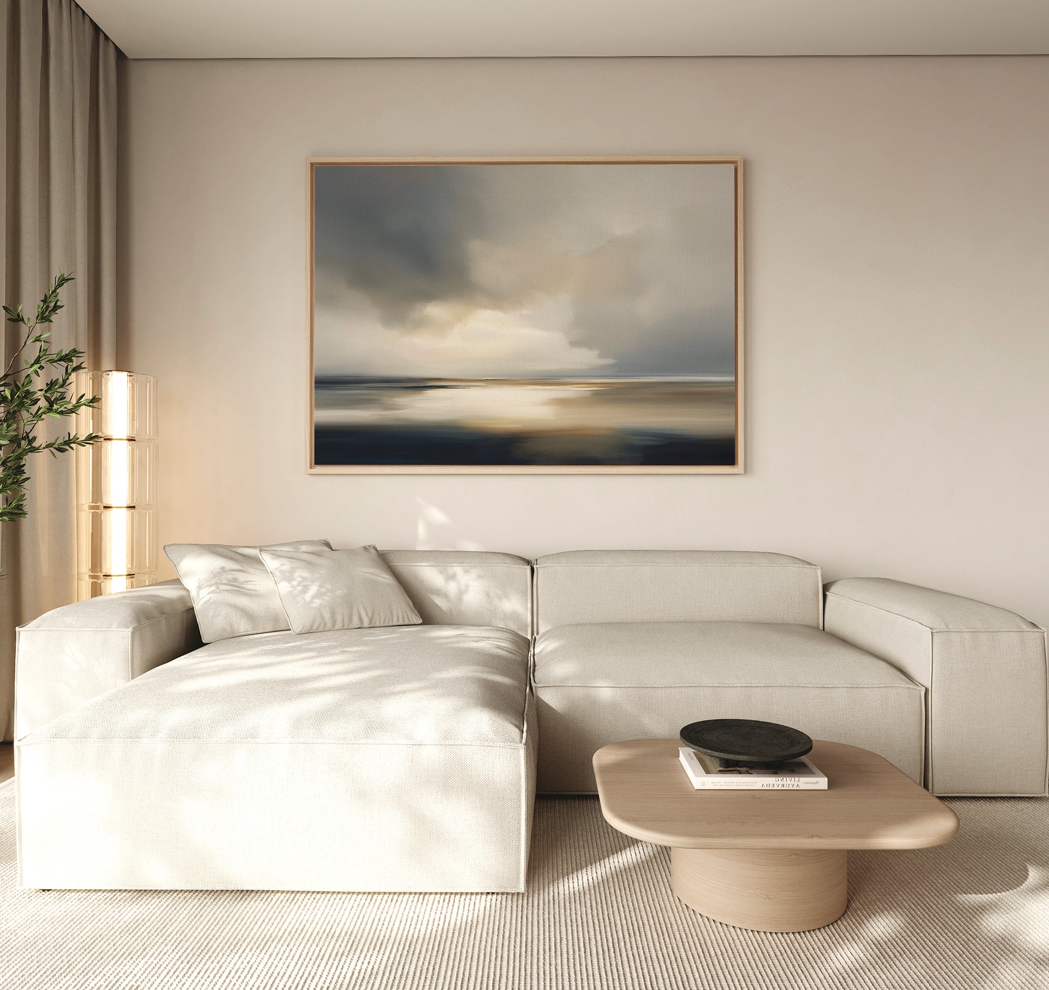 A modern living room with a beige sectional sofa, light wood coffee table with a black bowl, tall lamp, green plant, and the Stormy Tides Canvas Art - Horizontal above the sofa adds coastal elegance.