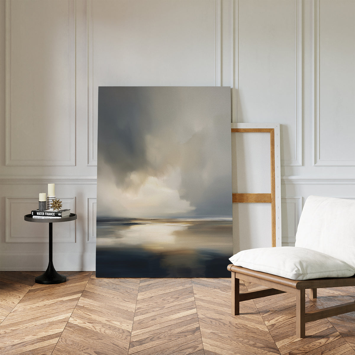 The Stormy Tides Canvas Art - Vertical leans against a white paneled wall in a modern room with herringbone wood floors, a light cushioned chair, round table, and candles—ideal for fans of coastal wall art.