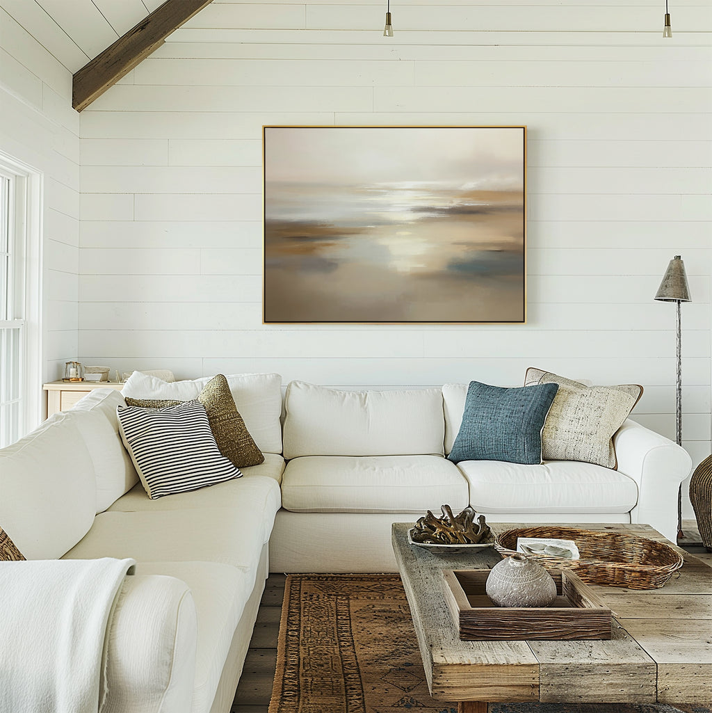 A bright living room with white shiplap walls, a spacious L-shaped sofa, rustic wood coffee table, and the Sunlit Waters Canvas Art - Horizontal above the couch. Natural light streams in from the left.