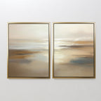 Sunlit Waters - Set Of 2: Two framed abstract paintings with soft beige, brown, cream, and light blue tones evoke a tranquil landscape or seascape, bringing calm to any white wall.