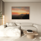 A modern living room featuring a light beige sectional sofa, a wooden coffee table, and the Sunset Reflection Canvas Art hanging above. Natural light filters through sheer curtains, creating a tranquil atmosphere.