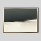 The Tempest Brewing Canvas Art - Horizontal features abstract wall art in a gold frame, with dark gray merging into off-white for a minimal, soft-blurred look—an atmospheric piece perfect for modern decor.