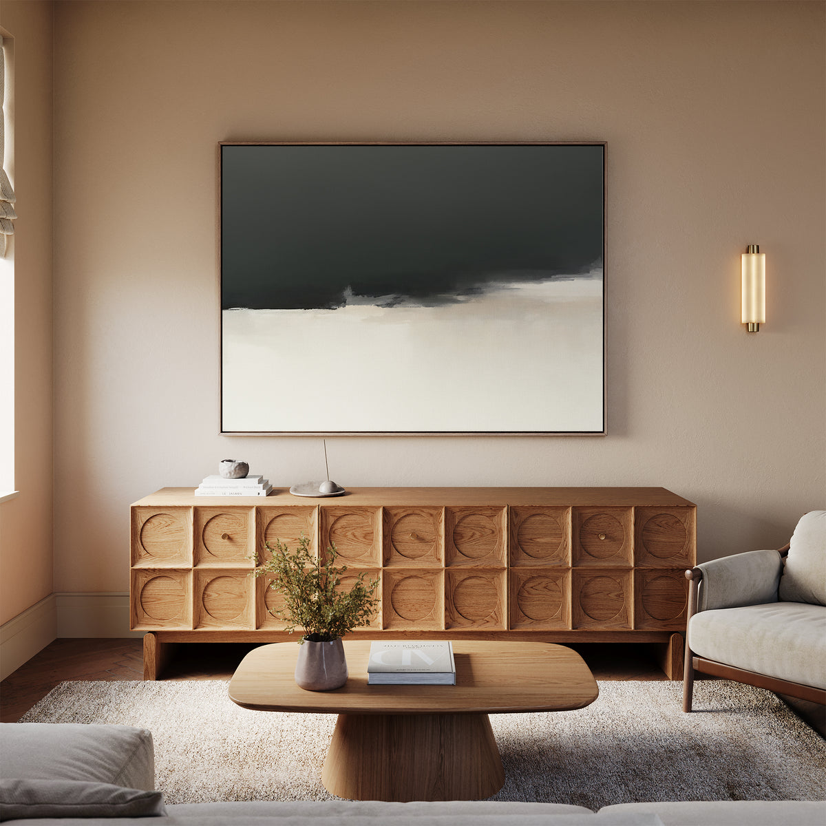 A modern living room with a wooden sideboard featuring circular patterns, Tempest Brewing Canvas Art - Horizontal above it, a light wood coffee table, beige sofa, small plant on the table, and soft neutral decor.