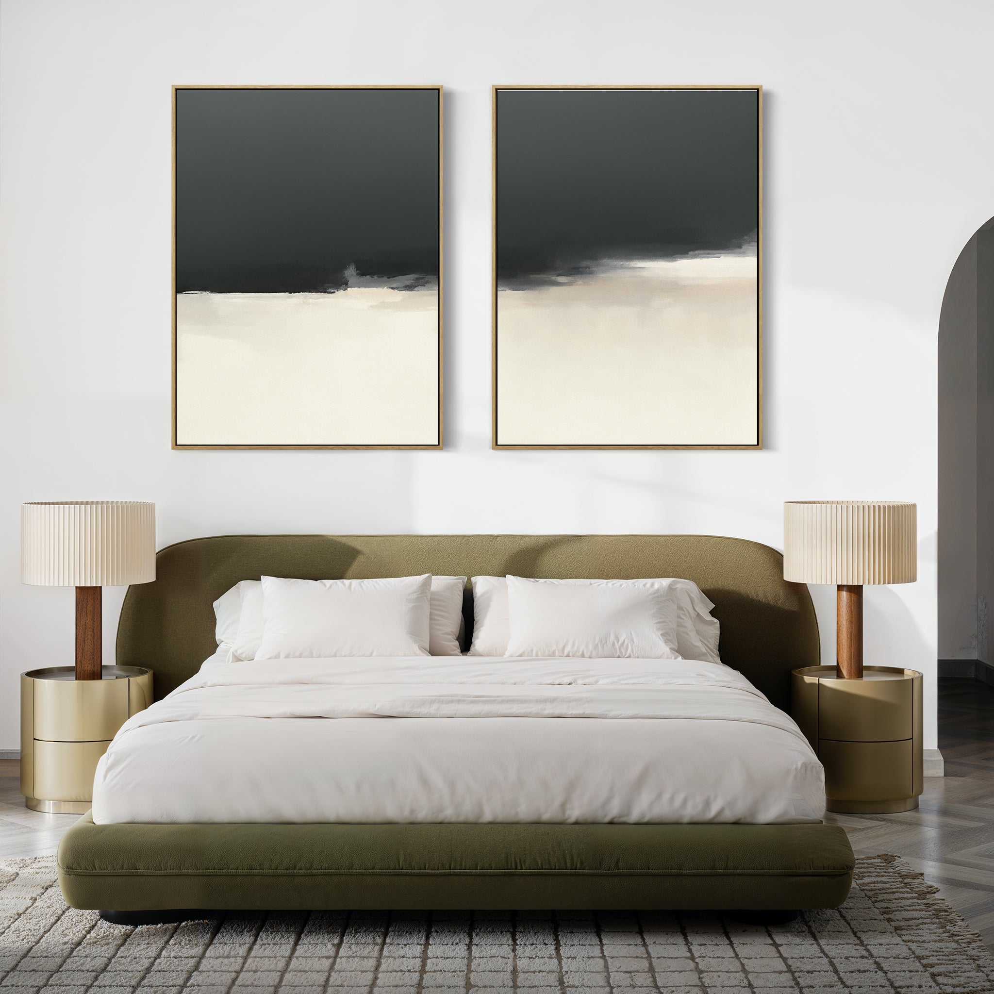 A modern bedroom with a green upholstered bed, white bedding, two gold nightstands with pleated lamps, and the Tempest Brewing - Set Of 2—large abstract black, white, and beige paintings—creating an atmospheric scene above the headboard.