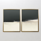 The Tempest Brewing - Set Of 2 features two abstract artworks with gold frames, each showcasing dark gray tops fading into beige and off-white bottoms, creating a minimalist and atmospheric wall art statement.