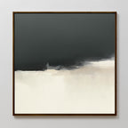 The Tempest Brewing Canvas Art - Square features a dark gray upper half blending into beige and white below, creating a soft, cloudy horizon. Finished in a thin dark wooden frame, this atmospheric piece adds depth to any wall.