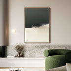 A modern living room with a green curved sofa, marble bench, dried flowers, and a round wall light features the Tempest Brewing Canvas Art - Vertical in dramatic tones—a striking touch inspired by Nordic Park aesthetics.