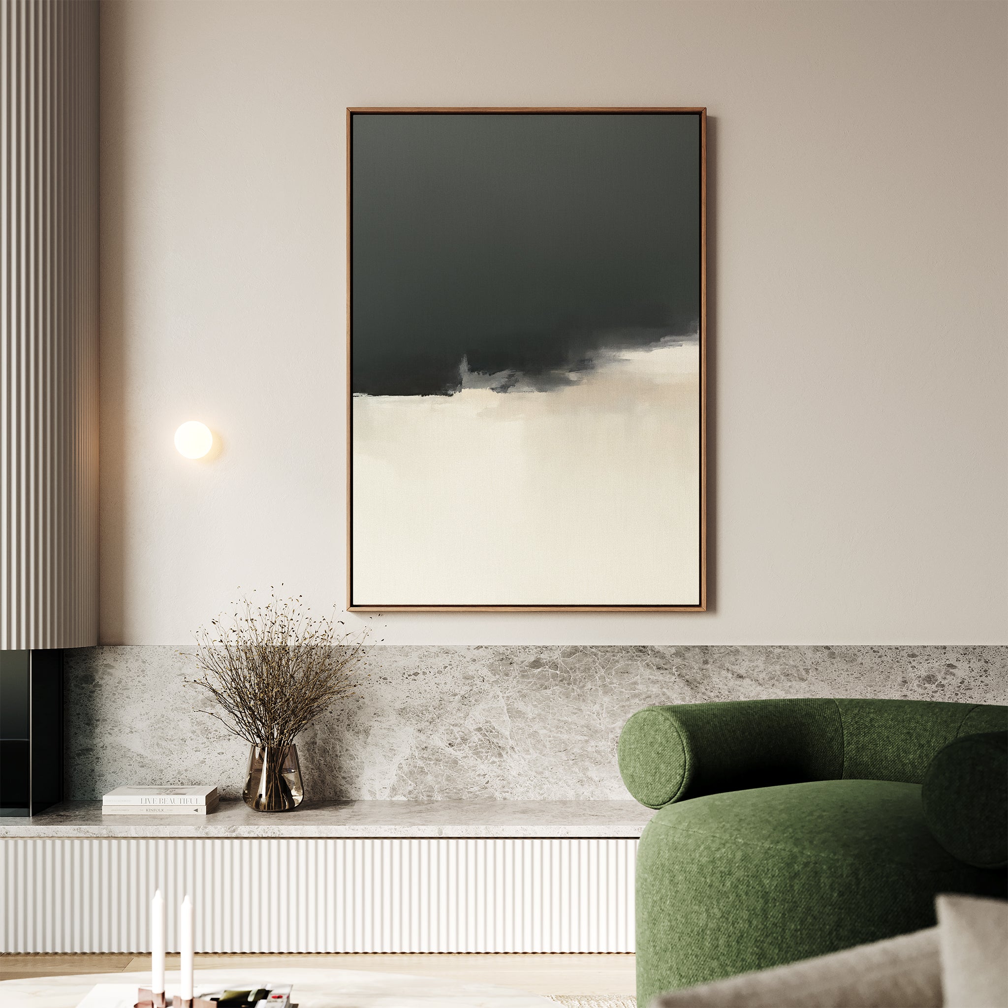 A modern living room with a green curved sofa, marble bench, dried flowers, and a round wall light features the Tempest Brewing Canvas Art - Vertical in dramatic tones—a striking touch inspired by Nordic Park aesthetics.