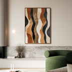 A modern living room features a green armchair, soft lighting, and the Wavy Patterns Abstract Canvas Art with black, brown, and beige shapes above a marble shelf. A vase of dried flowers adds an organic touch.