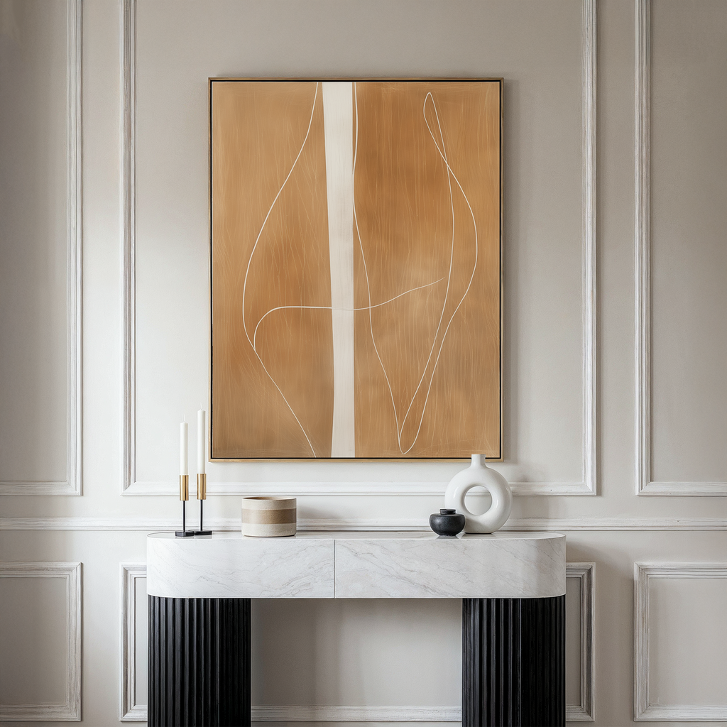 A modern console table with a marble top displays minimalist decor against a paneled wall. Above it hangs the Soft Brown Flow Abstract Canvas Art, in tan and white, perfect for elevating your living room style.
