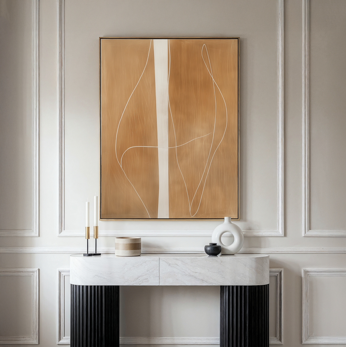 A modern console table with a marble top displays minimalist decor against a paneled wall. Above it hangs the Soft Brown Flow Abstract Canvas Art, in tan and white, perfect for elevating your living room style.