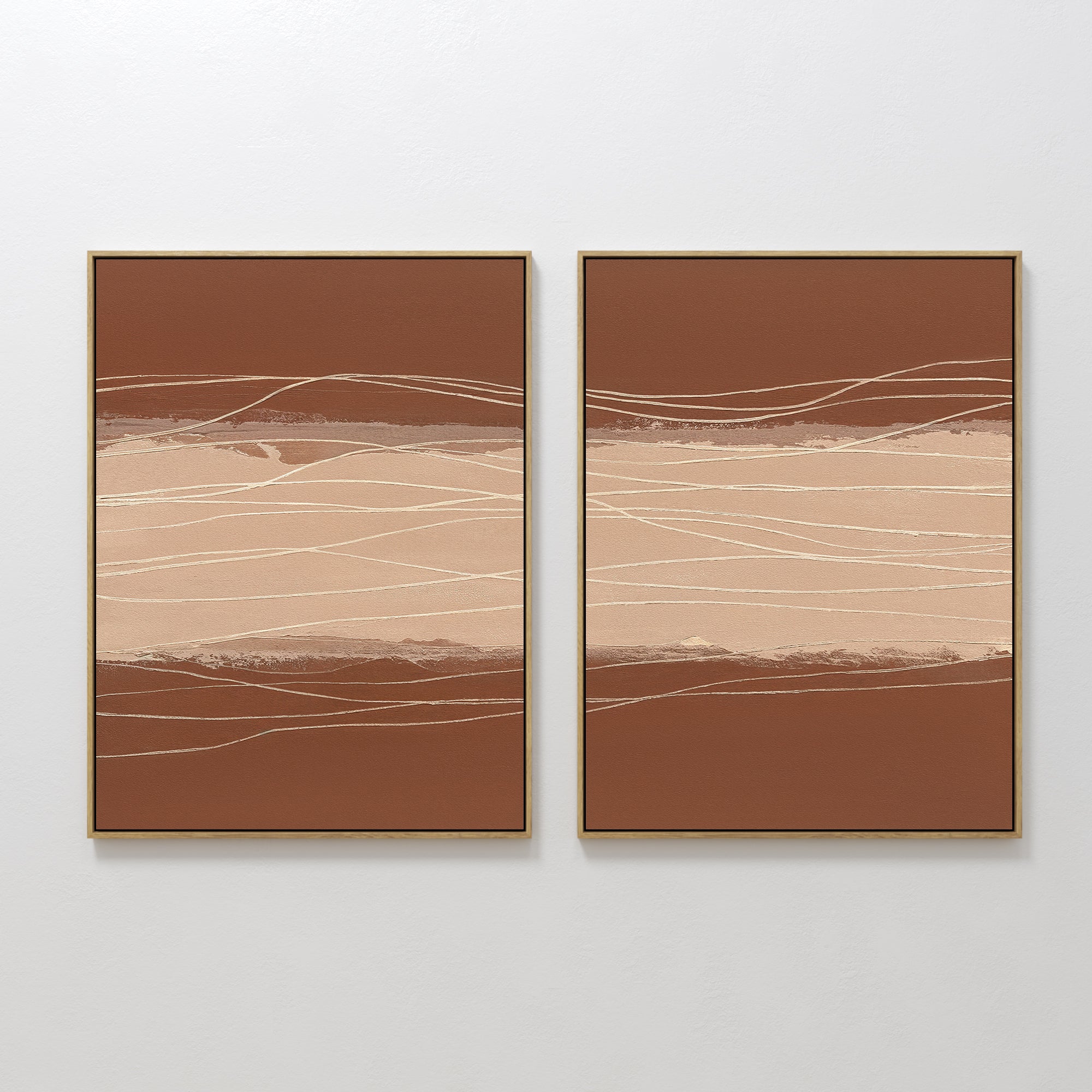 Terracotta Currents - Set Of 2 features abstract framed prints with earthy brown and beige hues, horizontal bands, and wavy white lines, offering modern elegance when displayed together on a white wall.