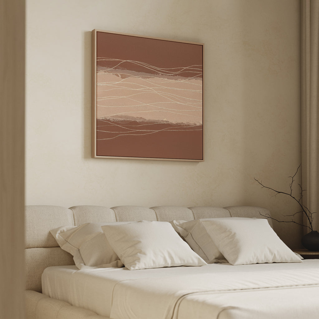A beige, minimalist bedroom features a tufted bed with cream bedding and pillows. Above it hangs the Terracotta Currents Canvas Art - Square, displaying earthy wavy lines and enhancing the serene Nordic Park atmosphere. A bare branch in a vase sits nearby.