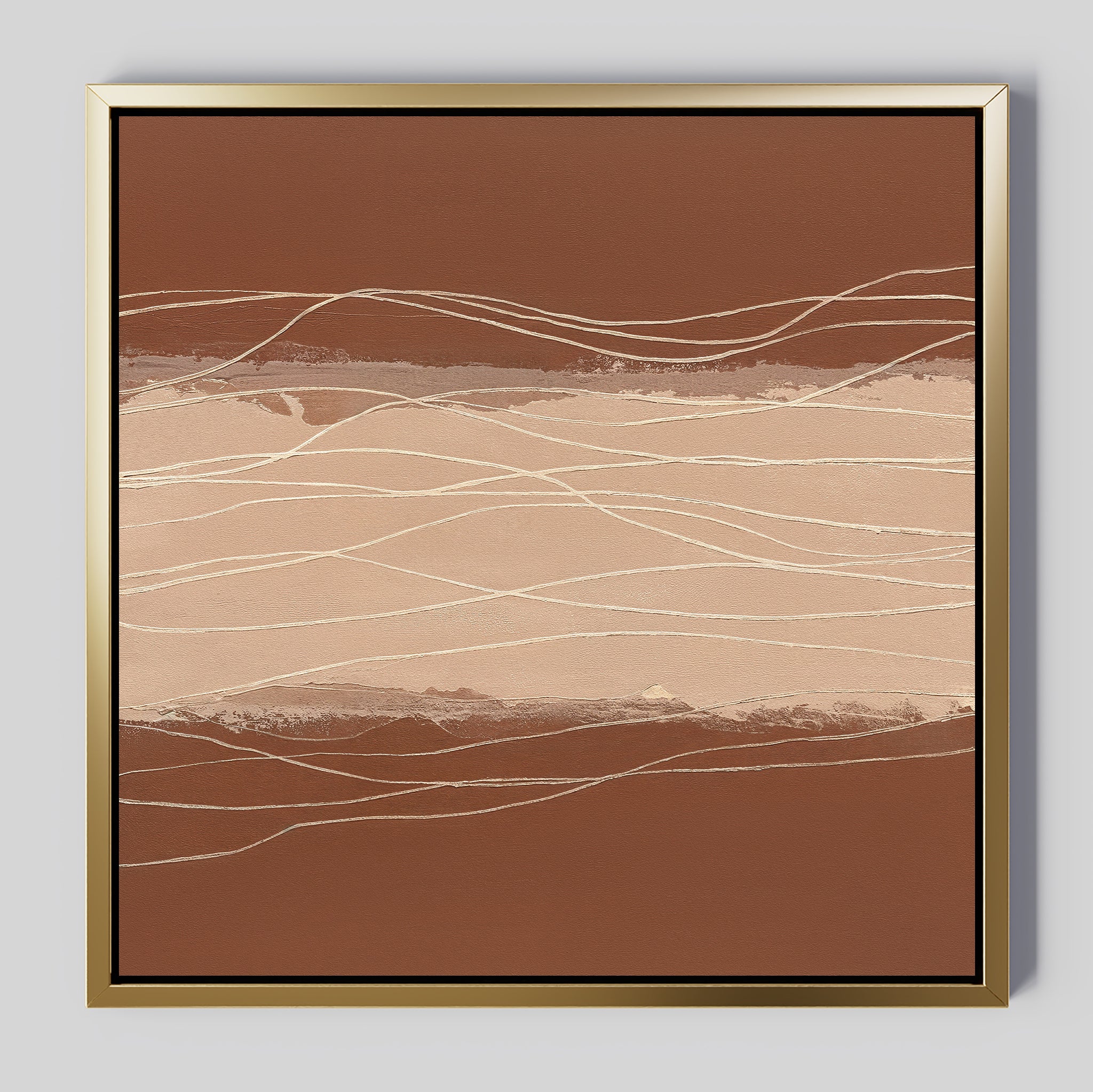 Terracotta Currents Canvas Art - Square features abstract warm brown and beige tones with thin, wavy white lines crossing horizontally. Elegantly framed in gold with a subtle shadow, it stands out against a neutral background.