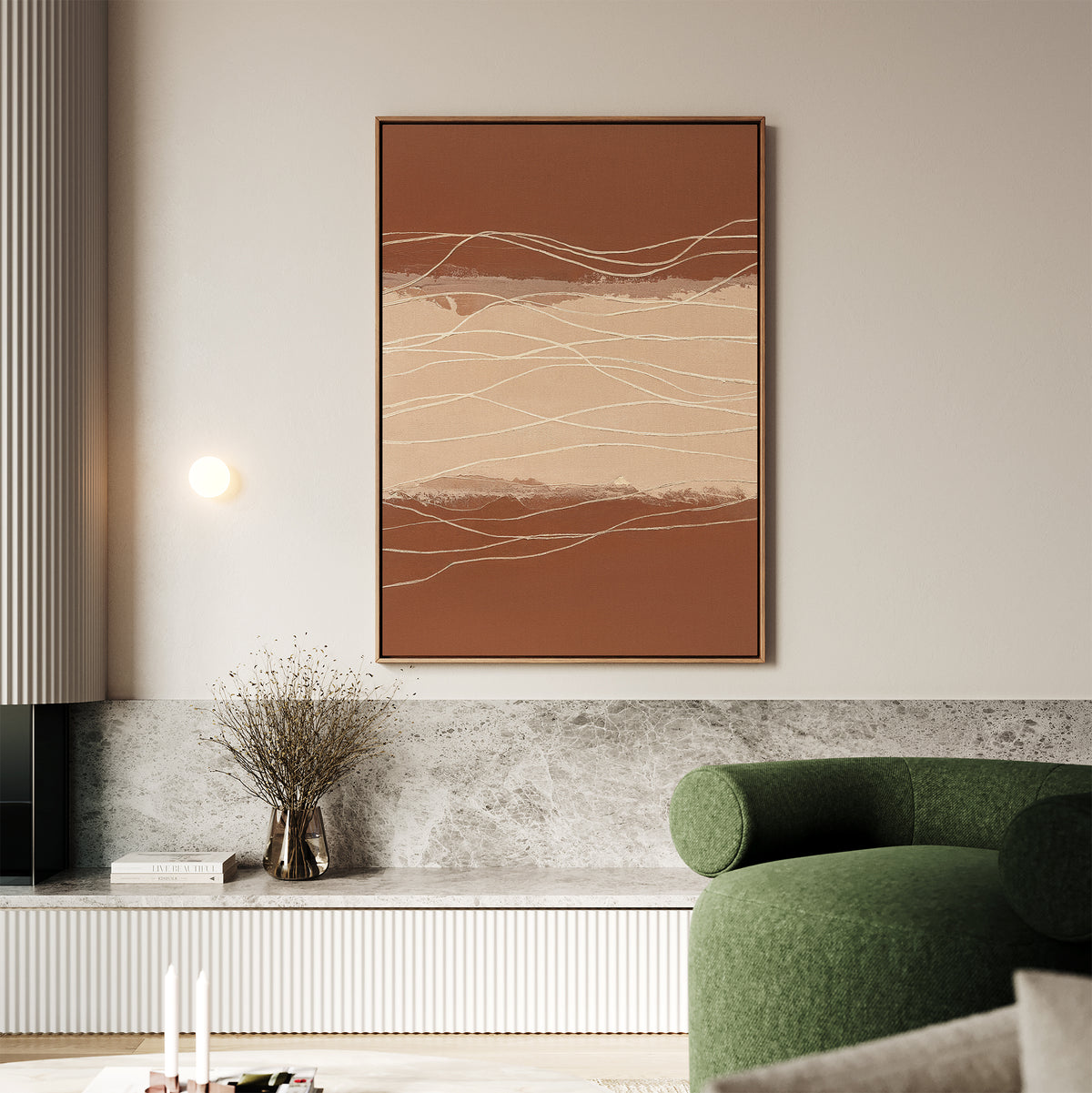 A modern living room features the Terracotta Currents Canvas Art - Vertical in earth tones, a green curved sofa, a marble shelf with dried flowers in a vase, and minimalist decor elements.