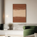 A modern living room features the Terracotta Currents Canvas Art - Vertical in earth tones, a green curved sofa, a marble shelf with dried flowers in a vase, and minimalist decor elements.