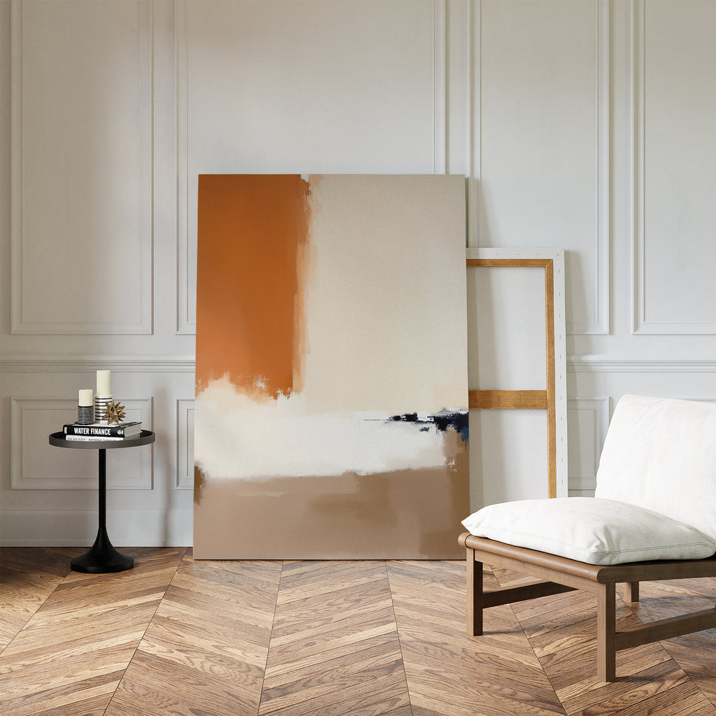 A minimalist room with herringbone wood floors, a white cushioned chair, black round table, and two Terracotta Edge Canvas Art - Vertical prints leaning against a white paneled wall.