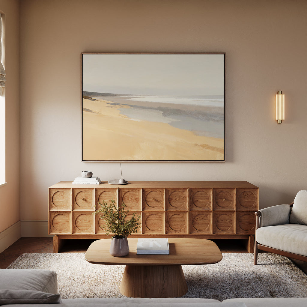 A cozy living room with a wooden coffee table, round vase with flowers, textured sideboard, and the Tidal Meditation Canvas Art - Horizontal above. Neutral tones and soft lighting create a calm, inviting atmosphere with tranquil wall art.