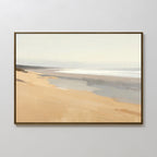 The Tidal Meditation Canvas Art - Horizontal features a serene beach with gentle waves and a pale sky, beautifully framed and displayed on a plain white wall.