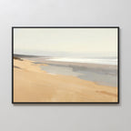 The Tidal Meditation Canvas Art - Horizontal features a serene beach with soft sands, gentle waves, and a pale sky, framed and displayed as tranquil wall art on a light-colored wall.