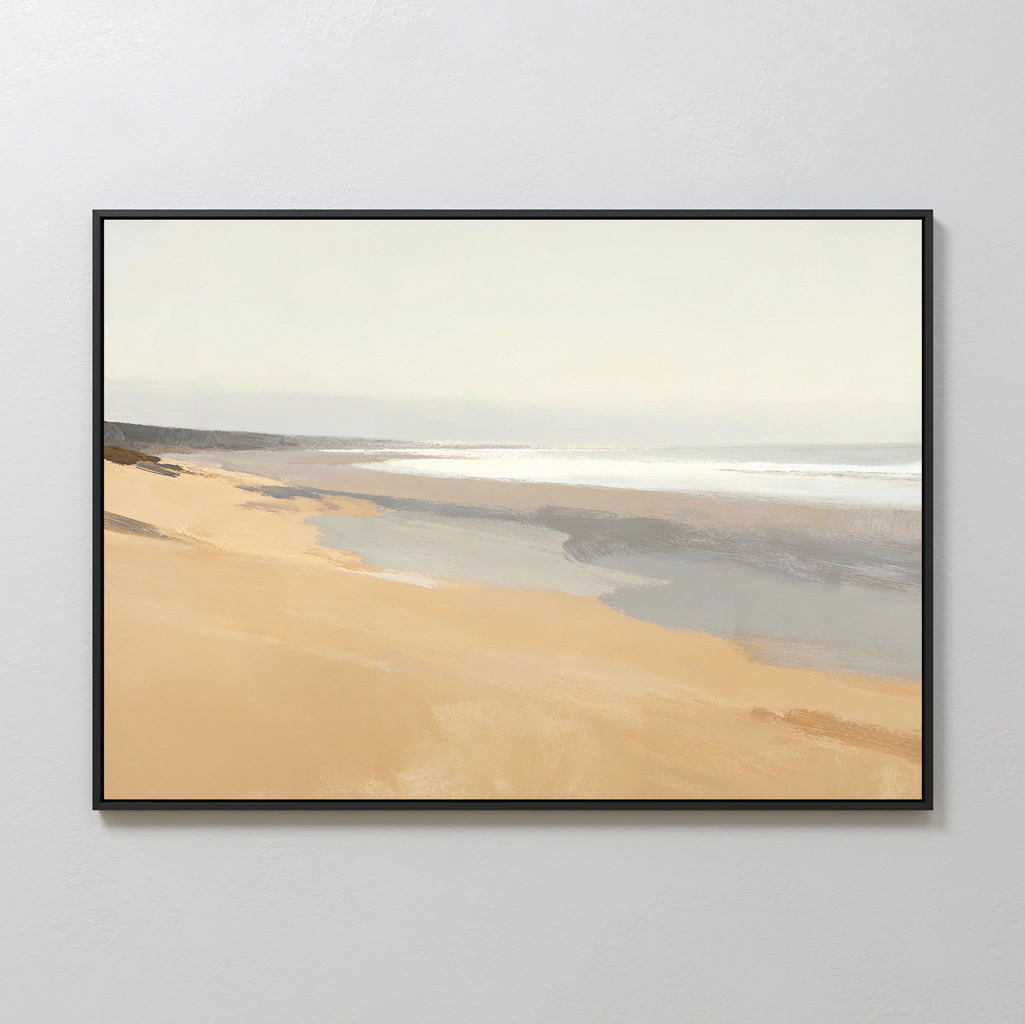The Tidal Meditation Canvas Art - Horizontal features a serene beach with soft sands, gentle waves, and a pale sky, framed and displayed as tranquil wall art on a light-colored wall.