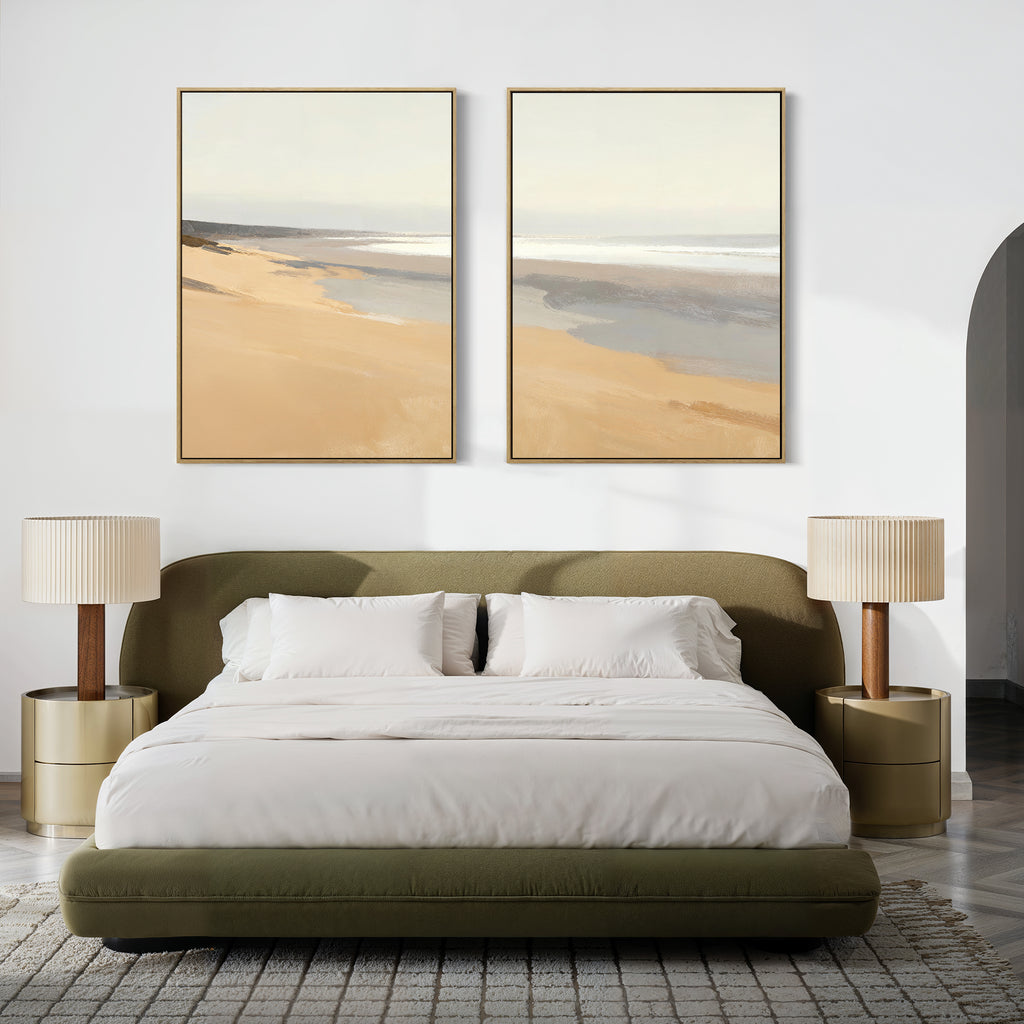 A modern bedroom with an olive green upholstered bed, white bedding, two beige nightstands with matching lamps, and tranquil decor featuring the "Tidal Meditation - Set of 2" coastal canvas prints above the bed.